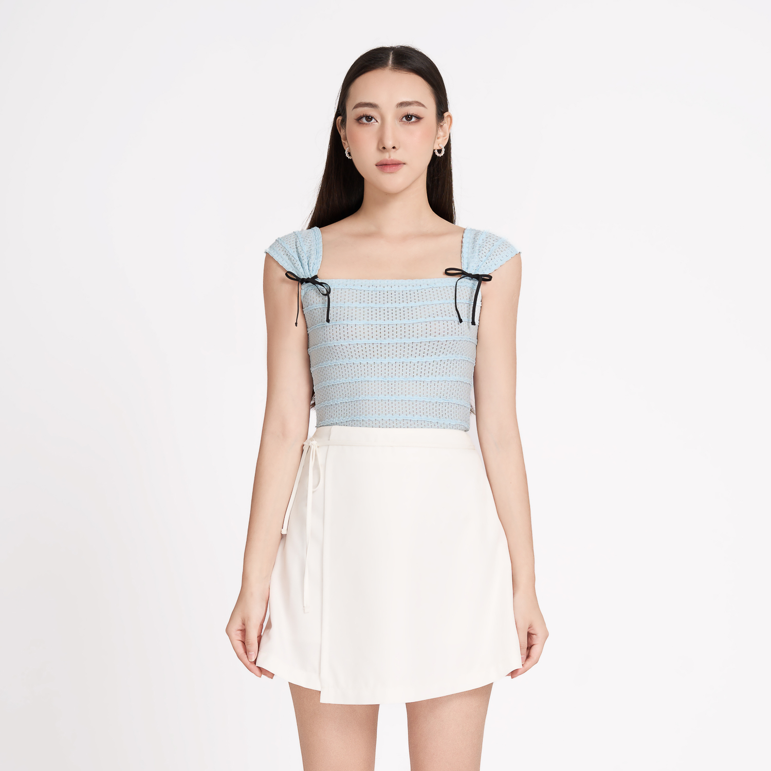 Chân váy mini cotton lạnh đắp tà phối dây nơ Maybi