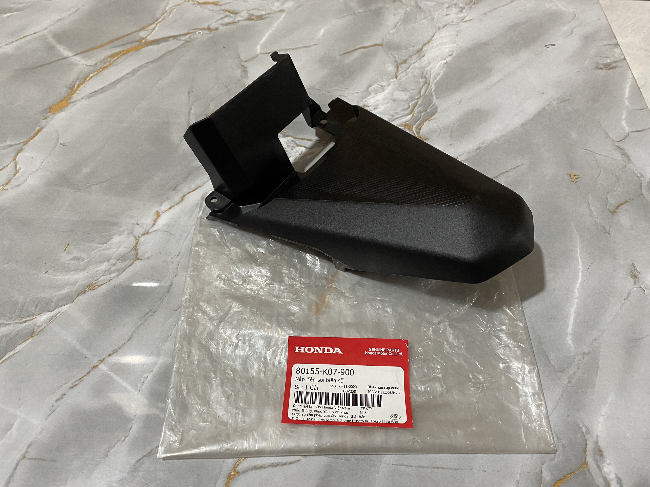 Nắp đèn soi biển số WAVE RSX 110 2012 màu đen (80155K07900)