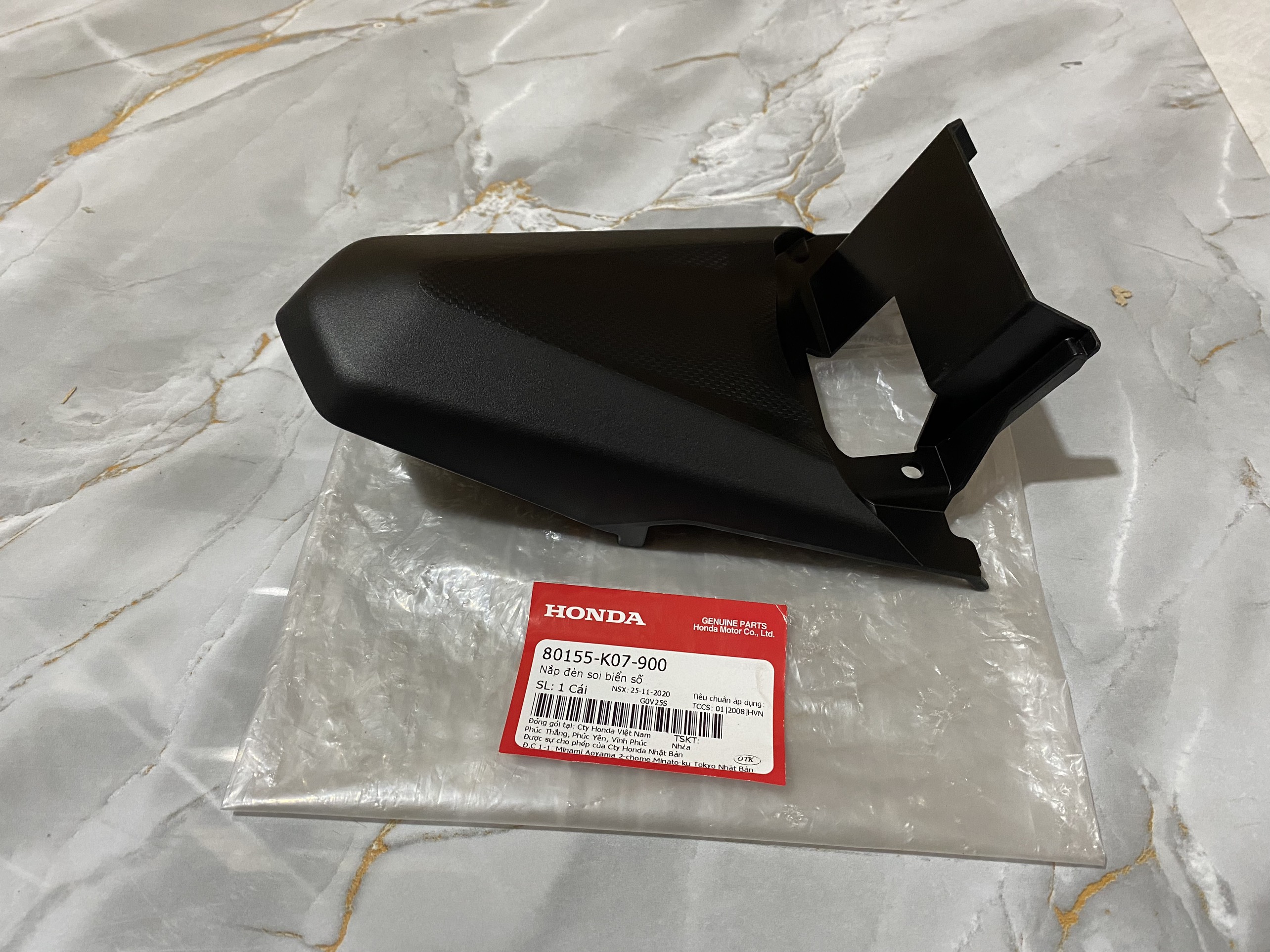 Nắp đèn soi biển số WAVE RSX 110 2012 màu đen (80155K07900)