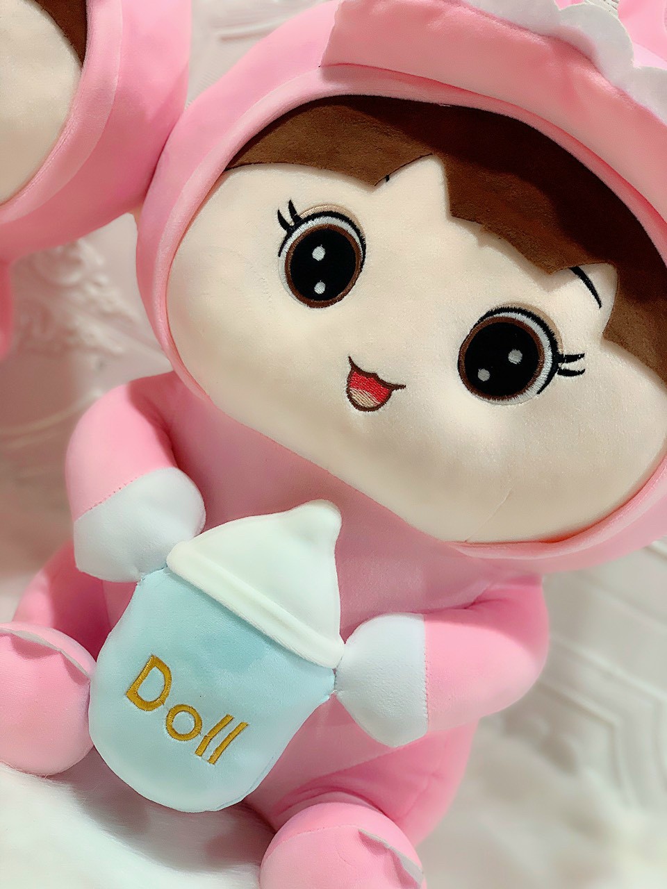 Doll (coslay dinosaur) hugging milk tank