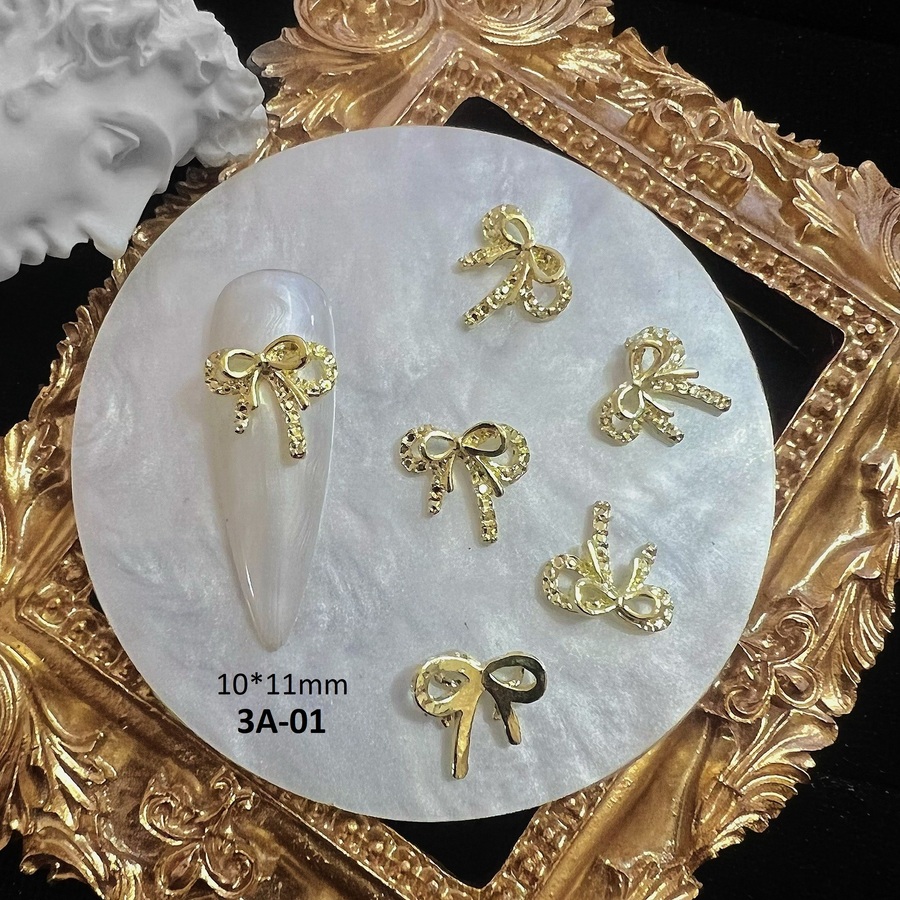 Charm nơ kim loại vàng bạc đính móng 3a