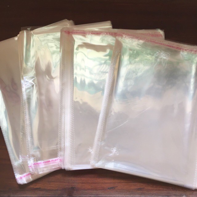 [HCM][RẺ VÔ ĐỊCH] 1 kg túi bọc ni lông bóng kiếng có keo dán miệng - bao có nắp đựng quần áo trẻ em người lớn hàng hóa bịch nilon lì xì hay trang sức - túi OPP nilong trong suốt bóng kính dán mép có nhiều kích thước