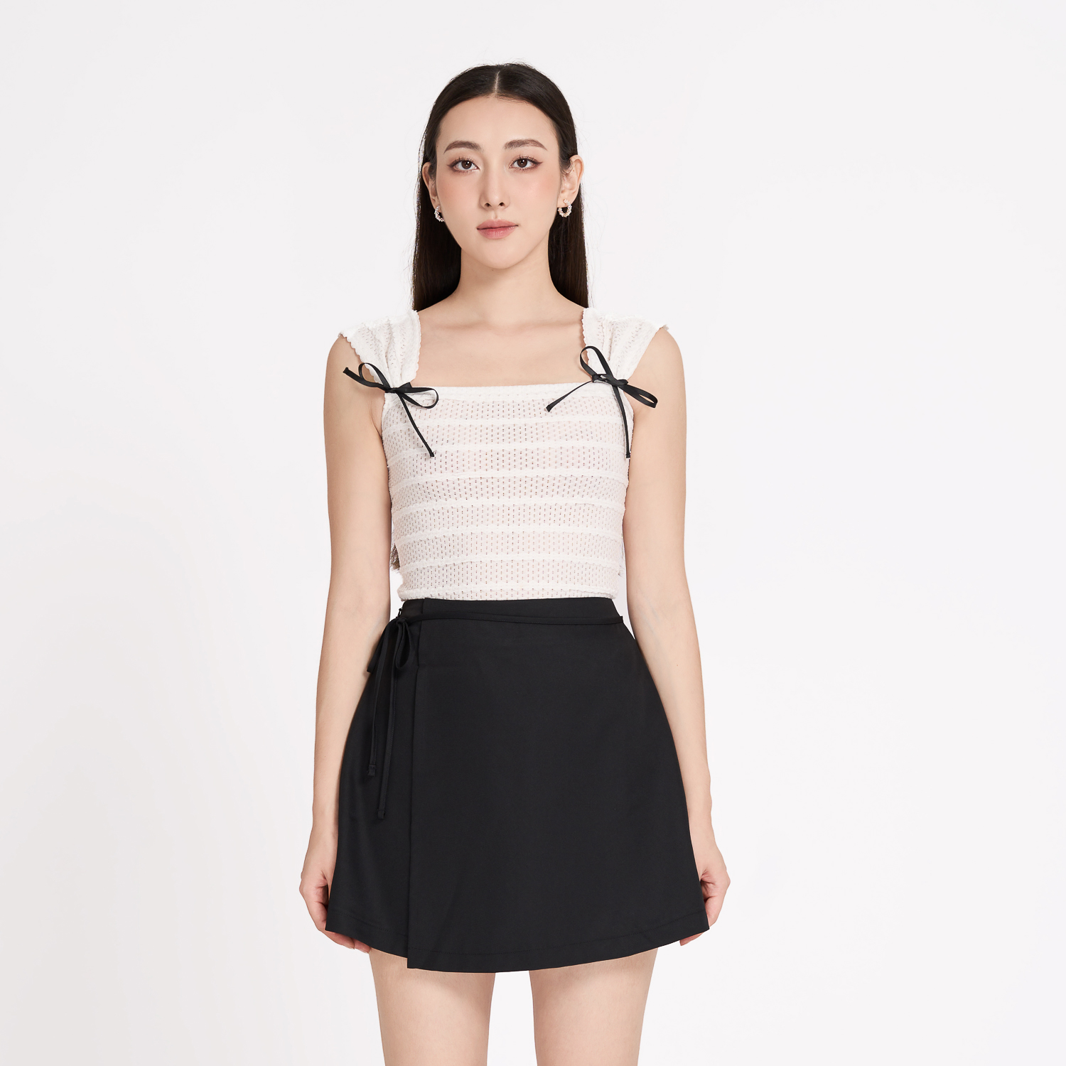 Chân váy mini cotton lạnh đắp tà phối dây nơ Maybi