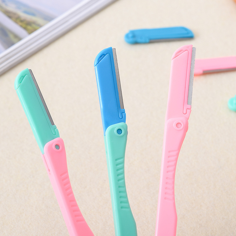 Utility mini eyebrow trimmer with replacement blades