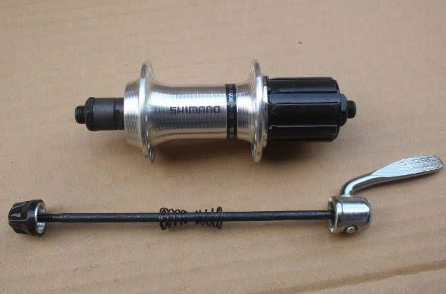 Moay ơ sau Shimano 32/36 lỗ phanh V, chất liệu hợp kim, cho xe líp thả 6-11 tầng (cối dài)