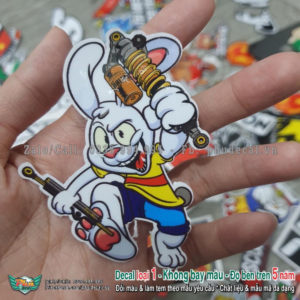 Tem dán sticker hình thỏ cầm phuộc size 6.5x8.3cm dán trang trí xe, điện thoại, nón bảo hiểm và các vật dụng khác