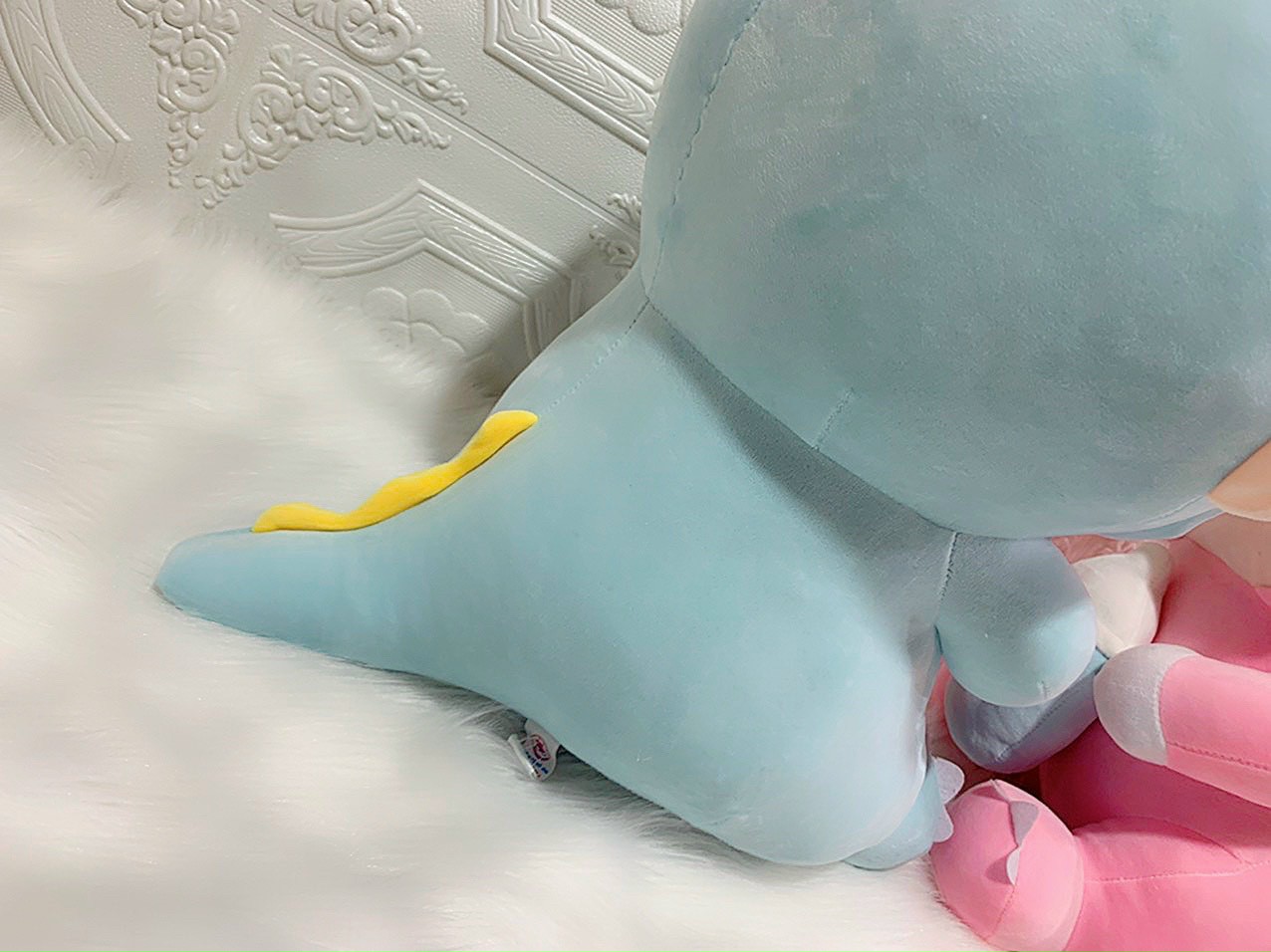 Doll (coslay dinosaur) hugging milk tank