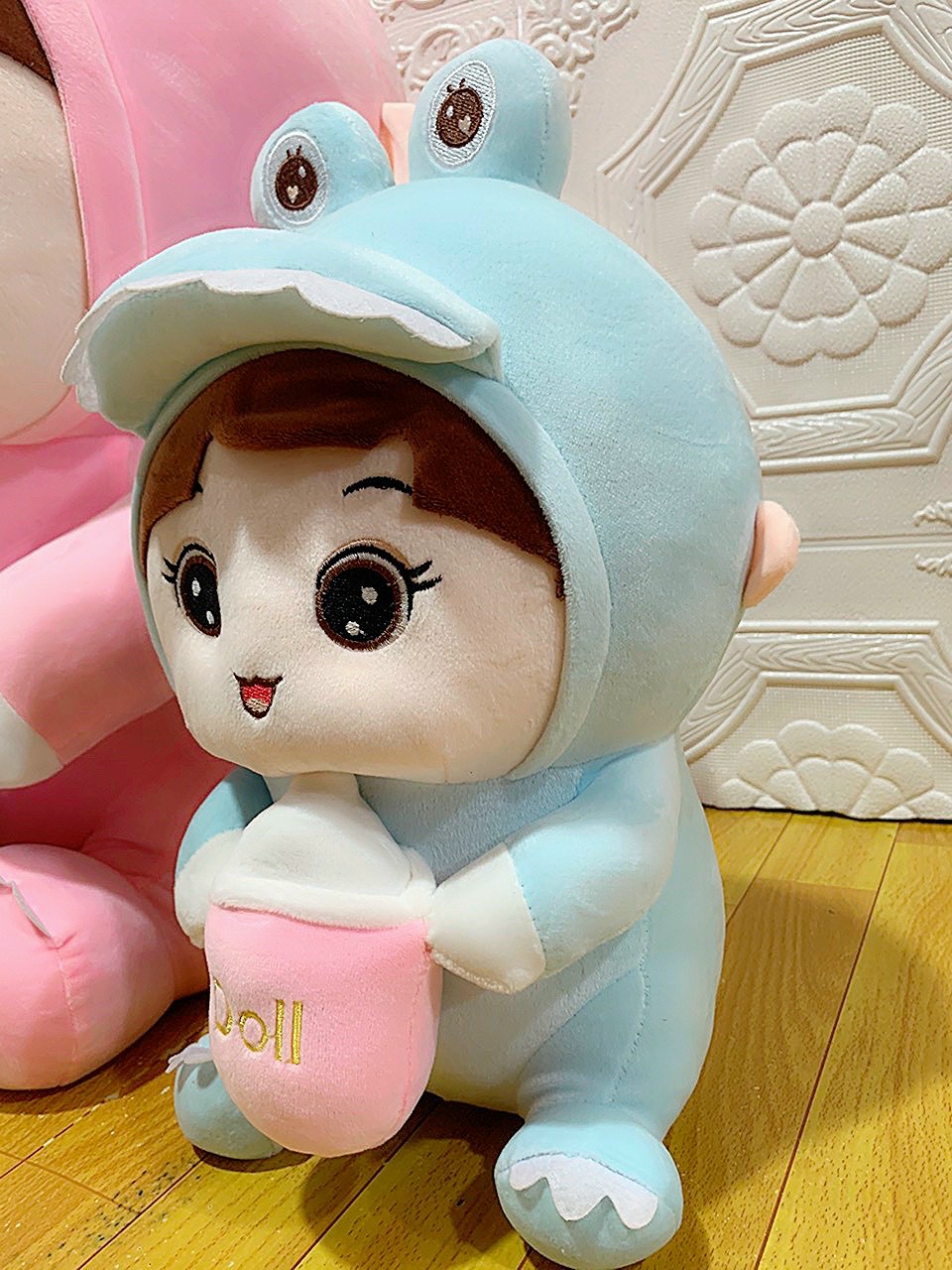Doll (coslay dinosaur) hugging milk tank