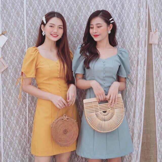 Đầm nút bọc tay nơ 2 màu