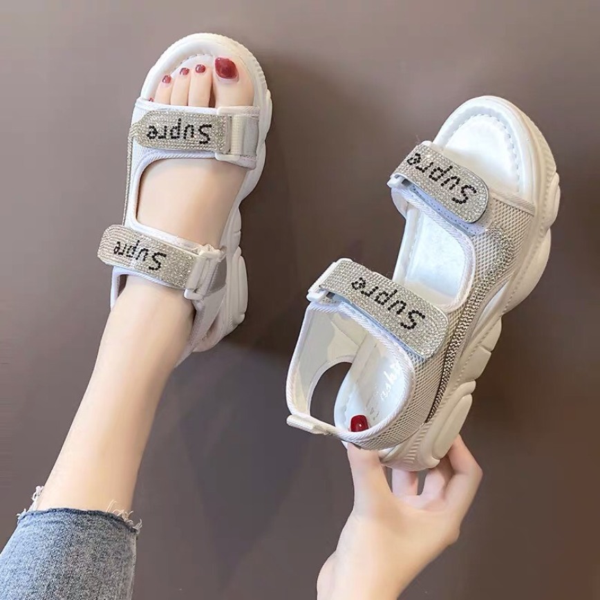 Sandal nữ đính hạt SUPRE có 2 màu đen, trắng, thiết kế quai ngang đế bằng, đế bánh mì hình gấu dễ thương, phong cách hàn quốc trẻ trung, dễ phối đồ, thích hợp sử dụng đi học, đi chơi, là mẫu dép quai hậu nữ hot mùa hè 2020 giá rẻ