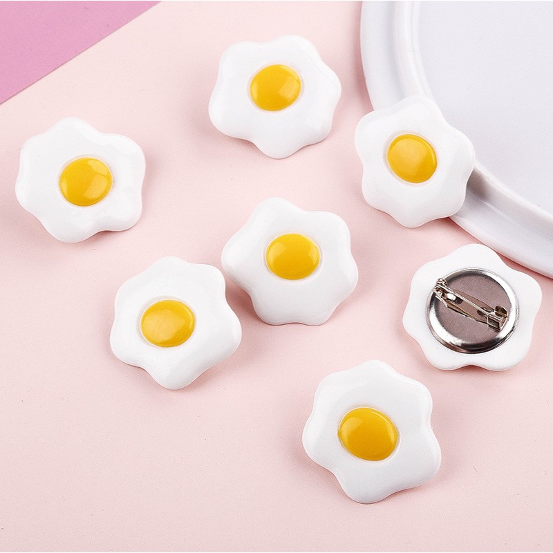 Huy hiệu gắn cặp, cài áo hình trứng