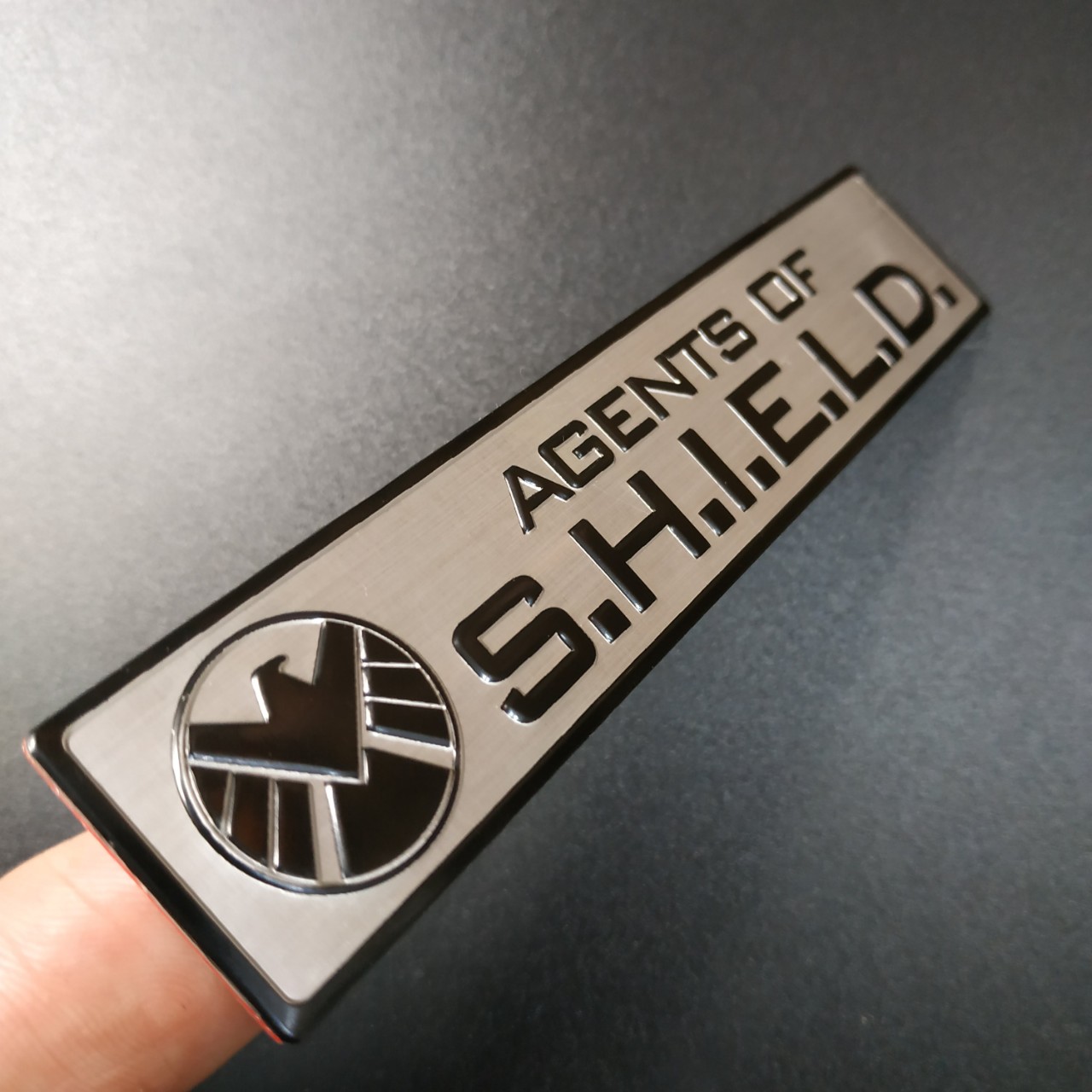 Tem nhôm dán xe SHIELD dài 12x2.6cm nền trắng