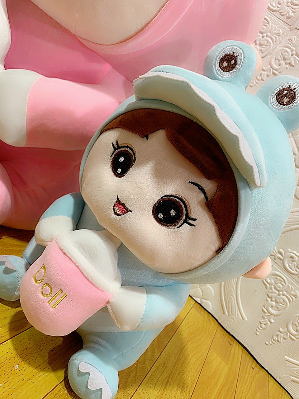 Doll (coslay dinosaur) hugging milk tank