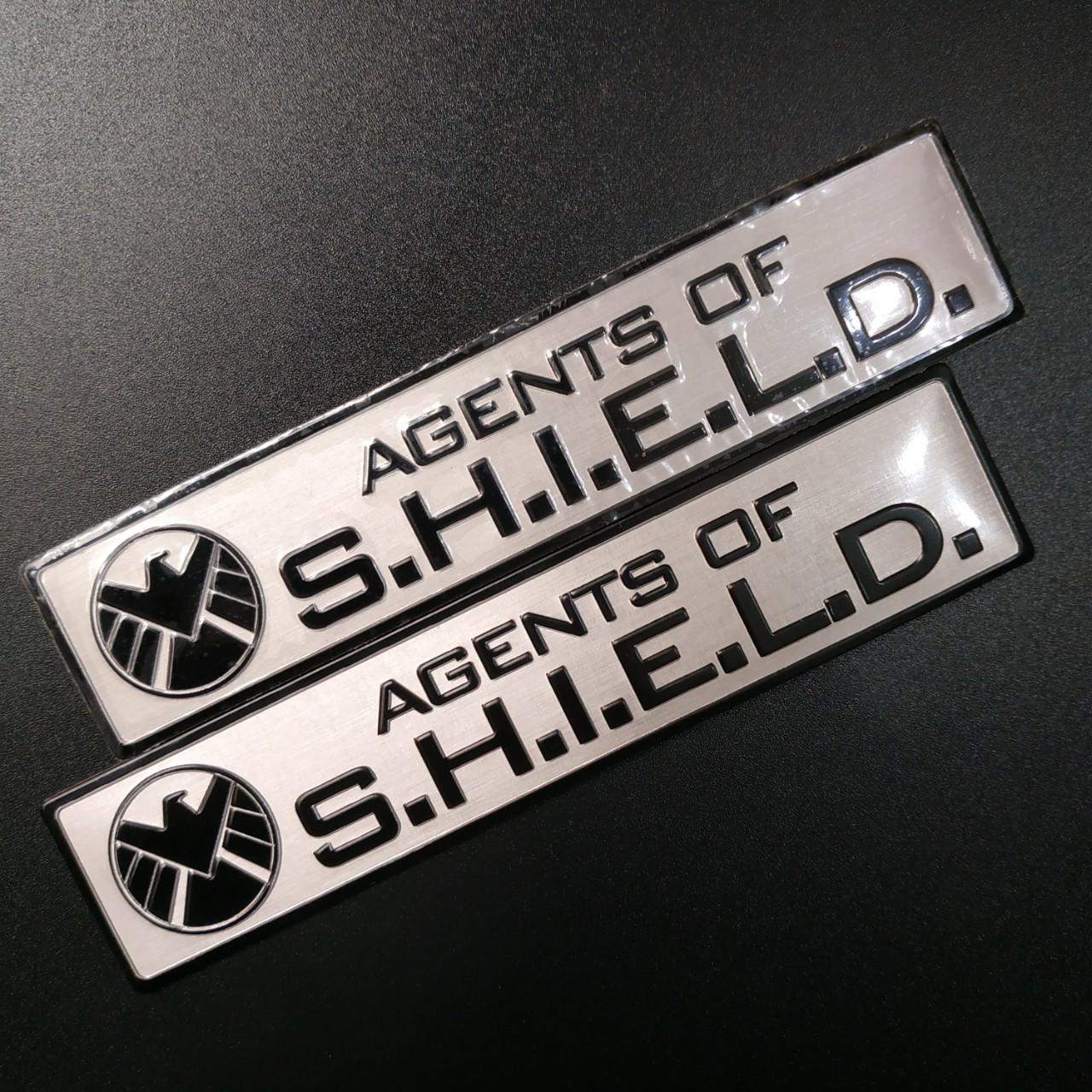 Tem nhôm dán xe SHIELD dài 12x2.6cm nền trắng