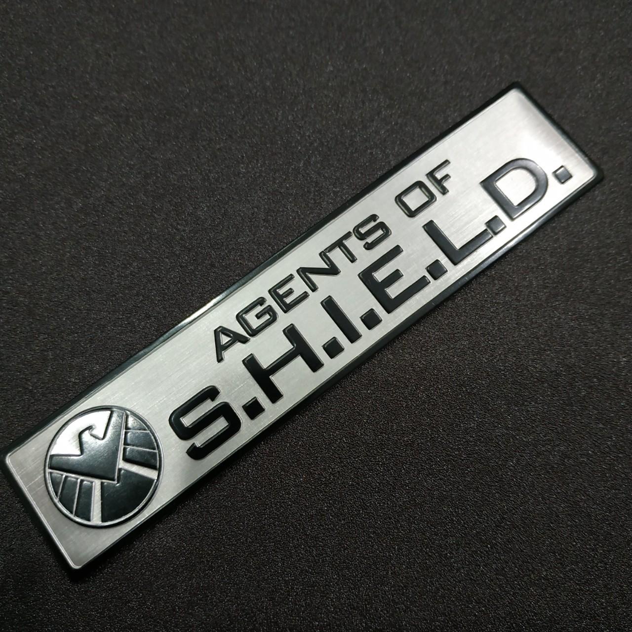 Tem nhôm dán xe SHIELD dài 12x2.6cm nền trắng