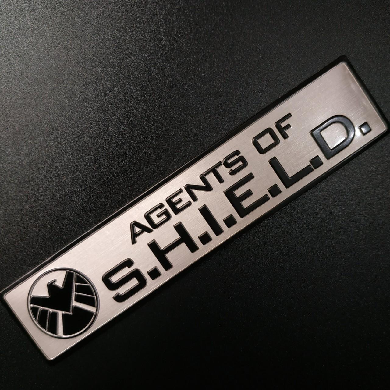Tem nhôm dán xe SHIELD dài 12x2.6cm nền trắng